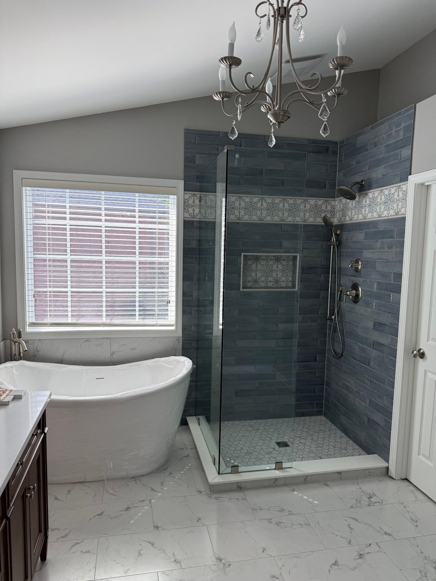 BlueBridge bathroom project with a freestanding bathtub and glass shower