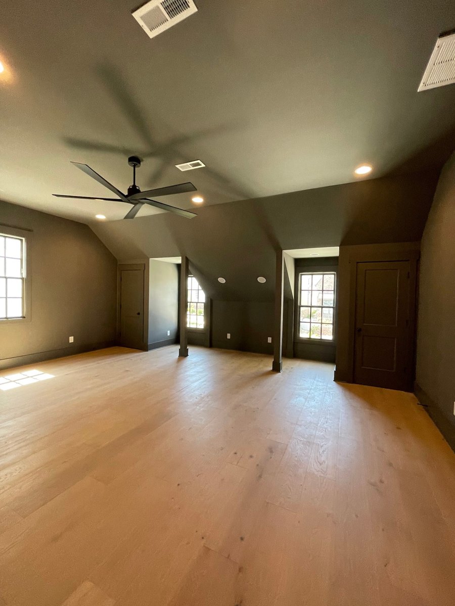 BlueBridge living space project with wood flooring and recessed lighting